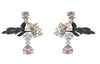 Pair of floral earrings with pink gemstones on a white background