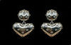 Silver heart-shaped earrings with embedded stones on a black background