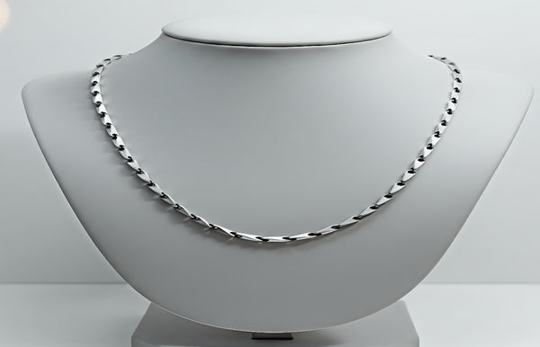 Necklace on a mannequin bust with a plain background