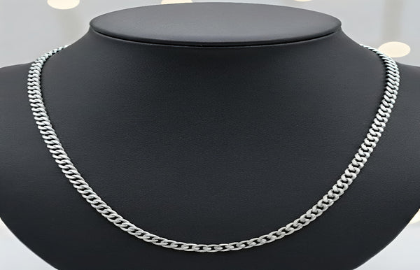 Silver chain necklace on a black mannequin bust with a white background