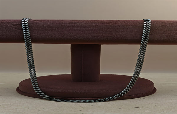 Metal chain on a brown stand against a beige background