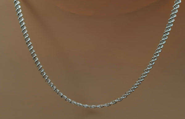 Silver rope chain necklace on a mannequin neck against a brown background