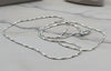 Silver chain necklace on a marble surface
